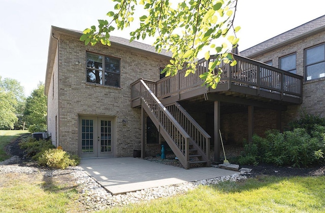 3893 Jocelyn Dr, Fairfield Twp, OH 45011 - back of property featuring french doors, brick siding, a wooden deck, a patio, and stairs