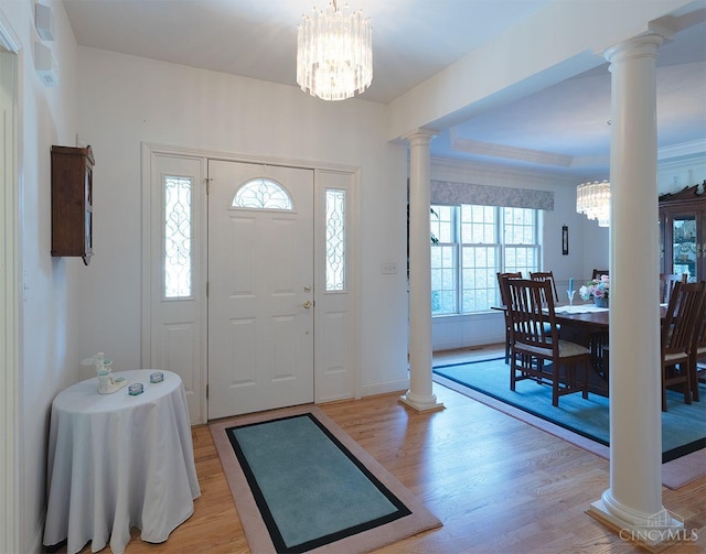 3893 Jocelyn Dr, Fairfield Twp, OH 45011 - entryway featuring ornate columns, light wood finished floors, a chandelier, and a tray ceiling