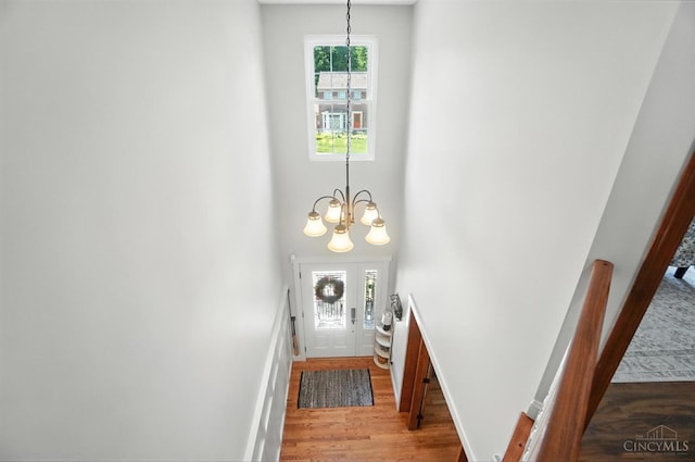 8608 Sunmont Dr, Anderson Twp, OH 45255 - doorway to outside featuring wood finished floors, a chandelier, and a high ceiling