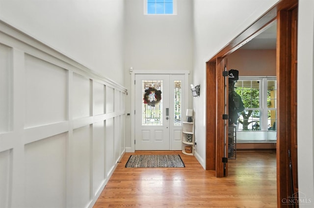 8608 Sunmont Dr, Anderson Twp, OH 45255 - entryway featuring a towering ceiling, light wood-style flooring, and plenty of natural light