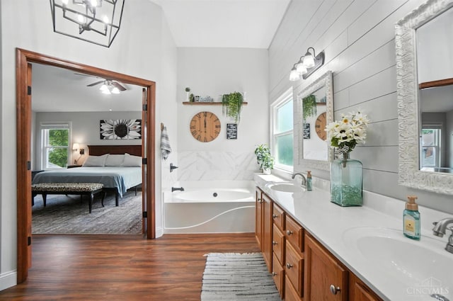 8608 Sunmont Dr, Anderson Twp, OH 45255 - full bath featuring double vanity, wood finished floors, a bath, ensuite bath, and ceiling fan