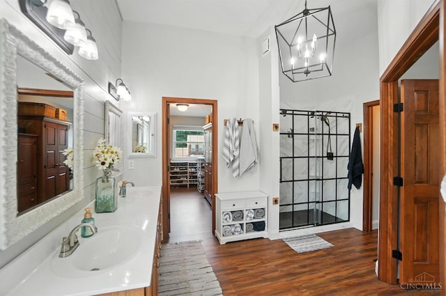 8608 Sunmont Dr, Anderson Twp, OH 45255 - full bathroom with a chandelier, double vanity, wood finished floors, and a shower