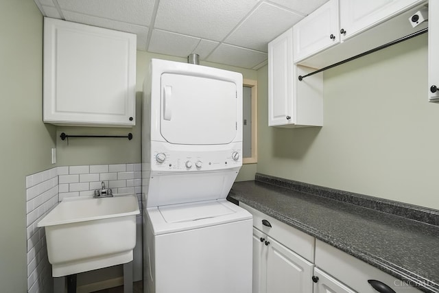 8608 Sunmont Dr, Anderson Twp, OH 45255 - laundry area featuring stacked washer / dryer and cabinet space
