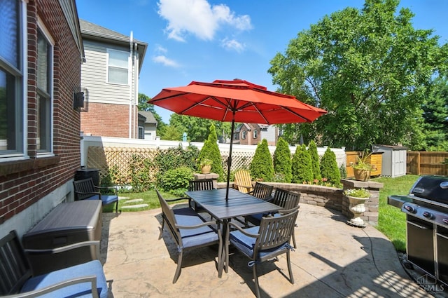 8608 Sunmont Dr, Anderson Twp, OH 45255 - fenced backyard featuring area for grilling, outdoor dining space, a patio, and a storage unit