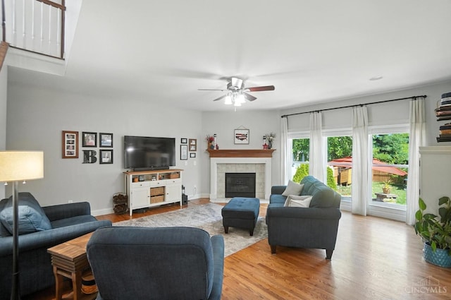 8608 Sunmont Dr, Anderson Twp, OH 45255 - living room with ceiling fan, wood finished floors, and a tiled fireplace