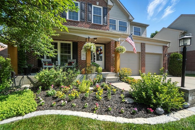 8608 Sunmont Dr, Anderson Twp, OH 45255 - view of front of home with brick siding, a porch, and driveway