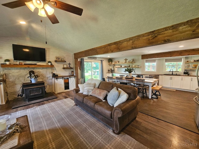 9063 Morrow Woodville Rd, Harlan Twp, OH 45162 - living area featuring hardwood / wood-style floors, ceiling fan, a wood stove, vaulted ceiling, and recessed lighting