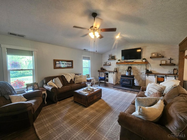 9063 Morrow Woodville Rd, Harlan Twp, OH 45162 - living room featuring a textured ceiling, a ceiling fan, lofted ceiling, and a wood stove