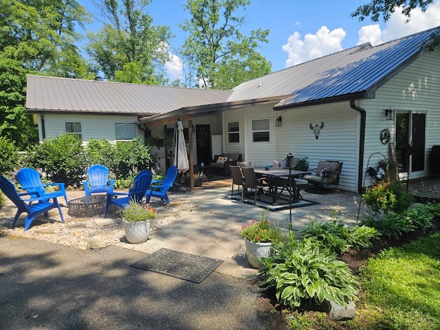 9063 Morrow Woodville Rd, Harlan Twp, OH 45162 - rear view of house featuring a patio and a metal roof