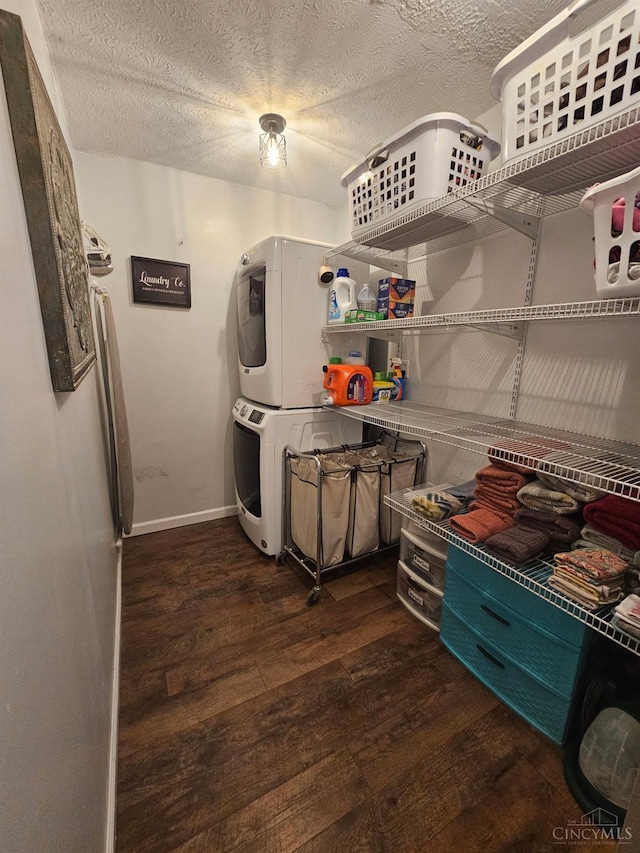9063 Morrow Woodville Rd, Harlan Twp, OH 45162 - kitchen with stacked washing machine and dryer, dark wood-style flooring, and a textured ceiling