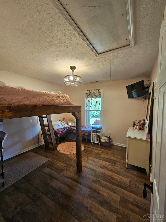 9063 Morrow Woodville Rd, Harlan Twp, OH 45162 - bedroom featuring attic access, a textured ceiling, and dark wood-type flooring