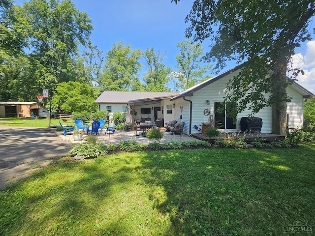 9063 Morrow Woodville Rd, Harlan Twp, OH 45162 - back of property with a yard and a patio area