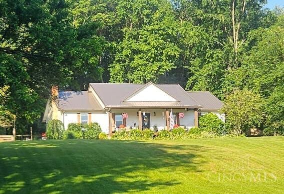 9063 Morrow Woodville Rd, Harlan Twp, OH 45162 - view of front facade with a front yard, a porch, and a chimney