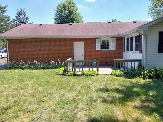 13353 State Route 28 W, Greenfield, OH 45123 - back of property featuring brick siding, a yard, a patio area, and roof with shingles