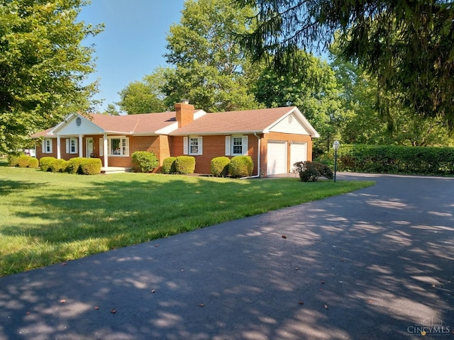 13353 State Route 28 W, Greenfield, OH 45123 - ranch-style house featuring a garage, brick siding, asphalt driveway, a chimney, and a front yard