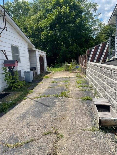 2320 Miles Rd, Colerain Twp, OH 45231 - view of yard with a garage and concrete driveway
