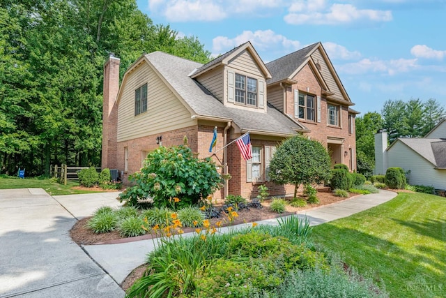 8551 Trillium Ridge Ln, Anderson Twp, OH 45255 - view of front of house with brick siding, a garage, a chimney, concrete driveway, and a front yard