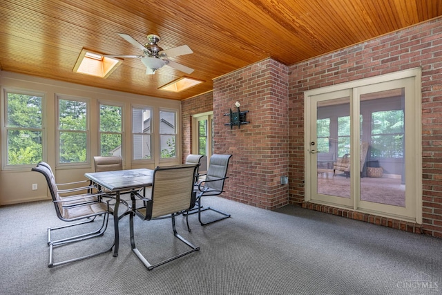 8551 Trillium Ridge Ln, Anderson Twp, OH 45255 - dining room with brick wall, a skylight, wooden ceiling, carpet floors, and a ceiling fan