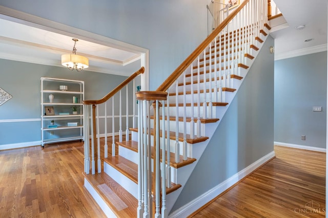 8551 Trillium Ridge Ln, Anderson Twp, OH 45255 - stairs featuring ornamental molding, wood finished floors, and a chandelier