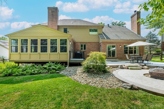 8551 Trillium Ridge Ln, Anderson Twp, OH 45255 - rear view of house with a yard, a patio, a chimney, and an outdoor fire pit