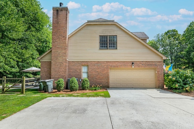 8551 Trillium Ridge Ln, Anderson Twp, OH 45255 - view of side of property with brick siding, a chimney, and concrete driveway