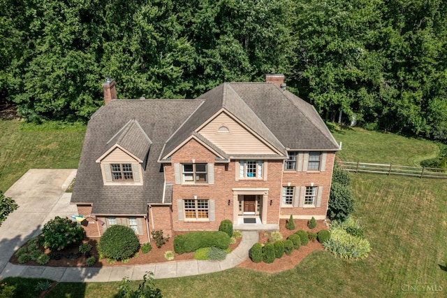 8551 Trillium Ridge Ln, Anderson Twp, OH 45255 - colonial house featuring a chimney, brick siding, and roof with shingles