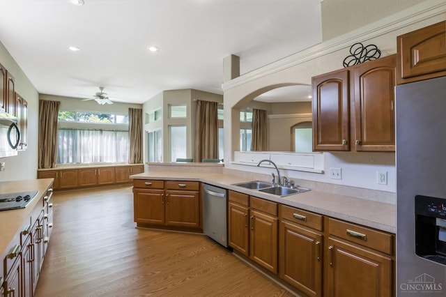 1301 Laurel Brook Way, Lebanon, OH 45036 - kitchen featuring stainless steel appliances, a ceiling fan, light countertops, light wood-style flooring, and brown cabinetry