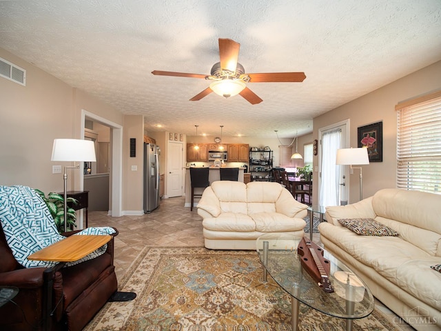 7854 Cape Cod Ct, West Chester, OH 45069 - living room featuring ceiling fan and a textured ceiling