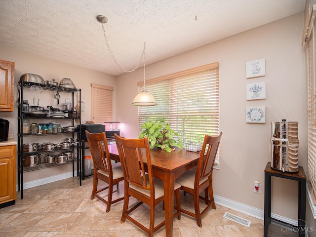 7854 Cape Cod Ct, West Chester, OH 45069 - dining space featuring a textured ceiling