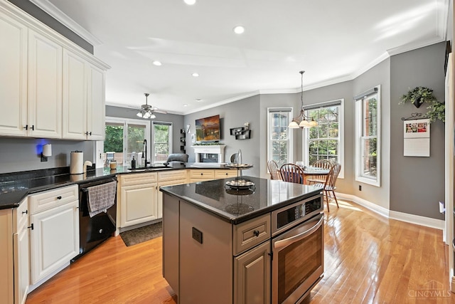 7066 Hearthside Ct, Liberty Twp, OH 45011 - kitchen with dishwasher, stainless steel oven, light wood-type flooring, recessed lighting, and a ceiling fan