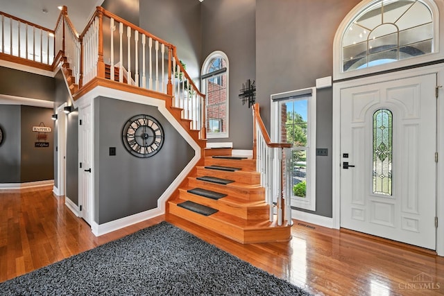 7066 Hearthside Ct, Liberty Twp, OH 45011 - foyer entrance with wood finished floors, a towering ceiling, and stairway