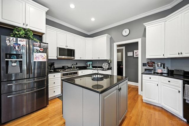 7066 Hearthside Ct, Liberty Twp, OH 45011 - kitchen with appliances with stainless steel finishes, white cabinetry, recessed lighting, ornamental molding, and light wood finished floors