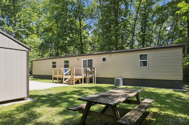 14697 Bodman Rd, Sterling Twp, OH 45154 - rear view of property with a wooden deck, crawl space, and a yard