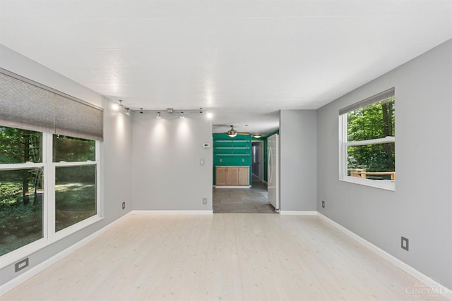 14697 Bodman Rd, Sterling Twp, OH 45154 - unfurnished room with light wood-type flooring, a ceiling fan, and rail lighting