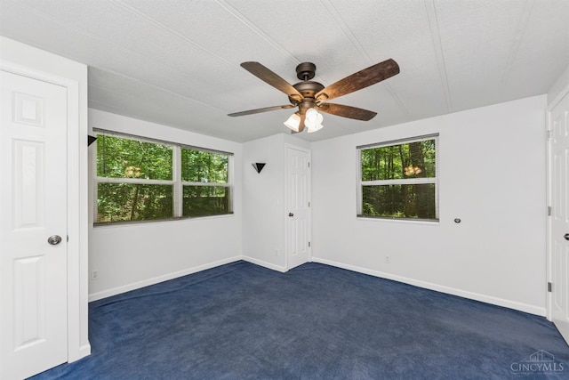 14697 Bodman Rd, Sterling Twp, OH 45154 - spare room featuring ceiling fan, dark carpet, and a textured ceiling