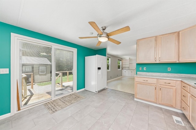 14697 Bodman Rd, Sterling Twp, OH 45154 - kitchen with white refrigerator with ice dispenser, light brown cabinets, ceiling fan, and light countertops