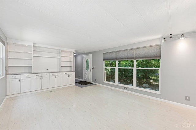 14697 Bodman Rd, Sterling Twp, OH 45154 - unfurnished living room featuring light wood-type flooring and baseboards