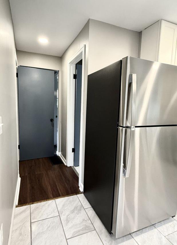 5424 Delhi Rd, Delhi Twp, OH 45238 - kitchen featuring freestanding refrigerator and white cabinets