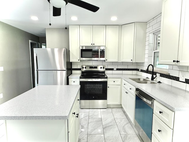 5424 Delhi Rd, Delhi Twp, OH 45238 - kitchen featuring stainless steel appliances, light marble finish flooring, a ceiling fan, white cabinets, and recessed lighting