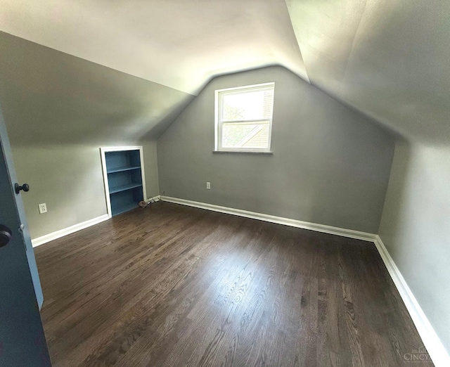 5424 Delhi Rd, Delhi Twp, OH 45238 - bonus room featuring built in features, dark wood finished floors, and vaulted ceiling