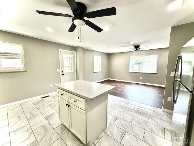 5424 Delhi Rd, Delhi Twp, OH 45238 - kitchen featuring ceiling fan, recessed lighting, light marble finish floors, freestanding refrigerator, and light countertops