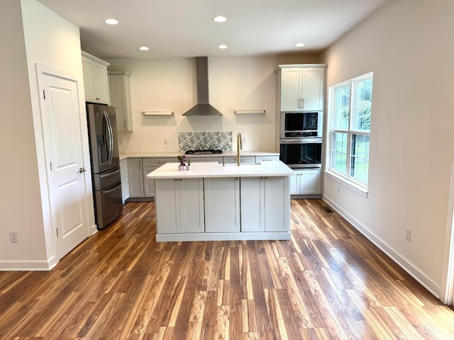 559 Foster-Maineville Rd, Hamilton Twp, OH 45039 - kitchen featuring appliances with stainless steel finishes, wall chimney range hood, light countertops, dark wood-style floors, and recessed lighting