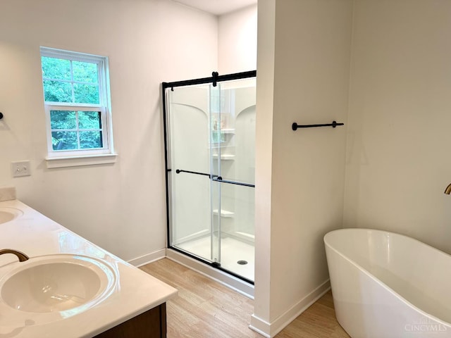 559 Foster-Maineville Rd, Hamilton Twp, OH 45039 - full bath with wood finished floors, double vanity, a soaking tub, and a stall shower
