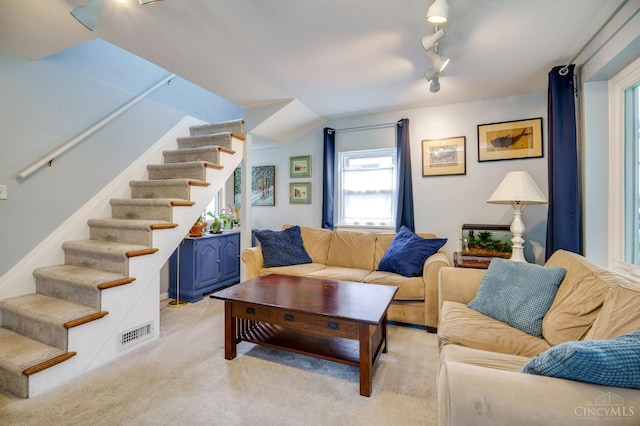 8012 Euclid Ave, Madeira, OH 45243 - living room with stairway, rail lighting, and light colored carpet