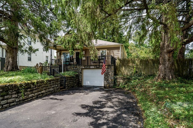 8012 Euclid Ave, Madeira, OH 45243 - view of front of home featuring stairs, asphalt driveway, a garage, and stone siding