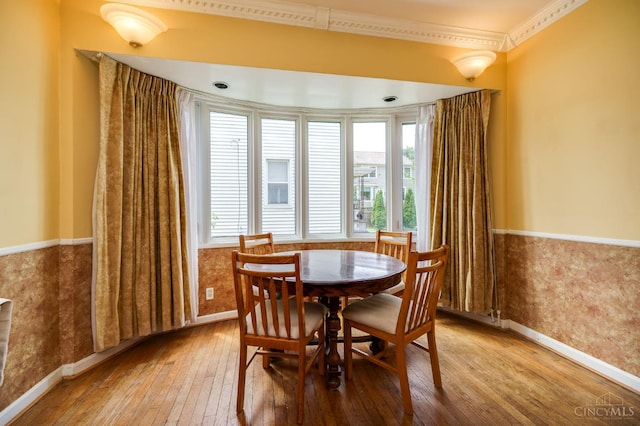 8012 Euclid Ave, Madeira, OH 45243 - dining space featuring hardwood / wood-style floors, healthy amount of natural light, crown molding, and a wainscoted wall