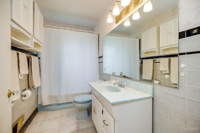 8012 Euclid Ave, Madeira, OH 45243 - bathroom with tile walls, vanity, shower / bath combo, and tile patterned flooring