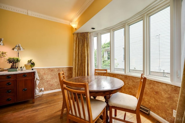 8012 Euclid Ave, Madeira, OH 45243 - dining room with light wood finished floors, wainscoting, and ornamental molding