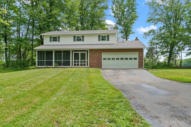 2535 Crane Schoolhouse Rd, Tate Twp, OH 45106 - view of front facade with driveway, a sunroom, a chimney, a front lawn, and a garage