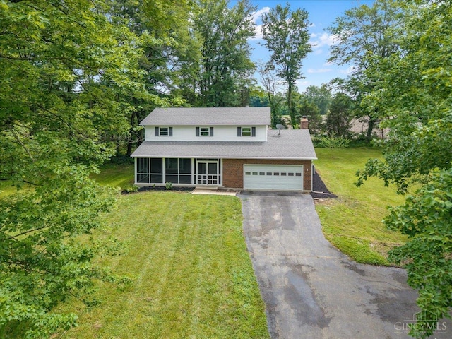 2535 Crane Schoolhouse Rd, Tate Twp, OH 45106 - traditional home with asphalt driveway, a sunroom, a garage, a chimney, and a front yard